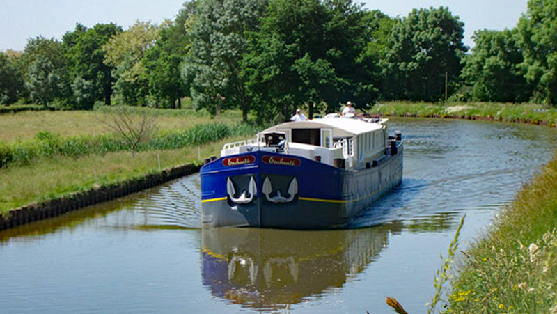 French Hotel Barge Enchante cruising along the Canal du Midi in the south of France