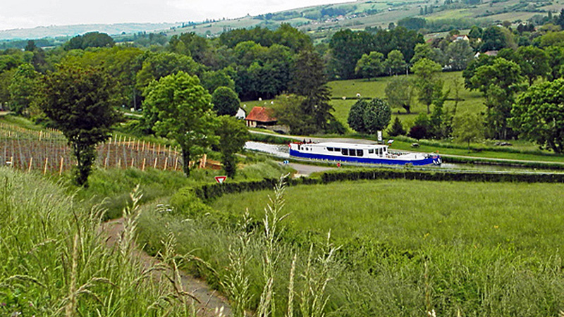 French Hotel Barge Finesse cruising through the Burgundy countryside in France