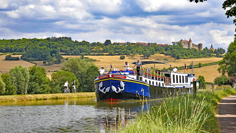 French Hotel Barge L'Impressionniste cruising along the Canal de Bourgogne in Burgundy France