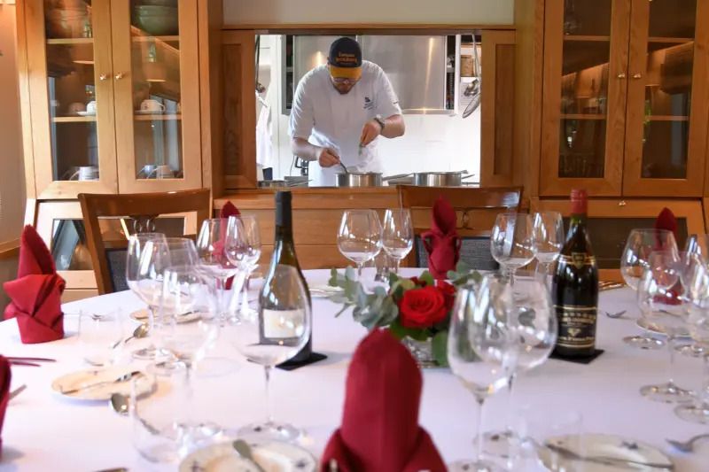 French Hotel Barge Kir Royale's chef preparing meal with dining table set