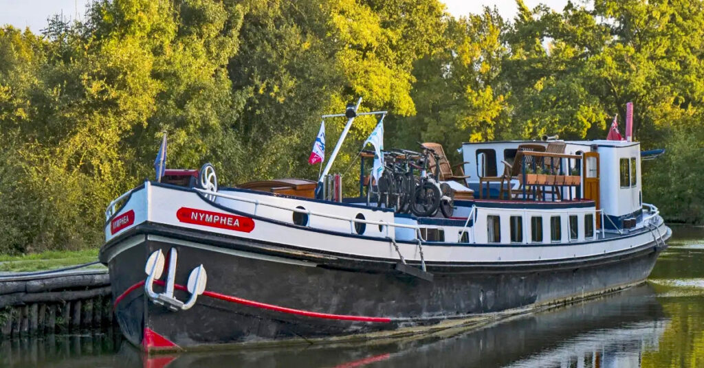 French Hotel Barge Nymphea on the bank of the canal in Brittany France