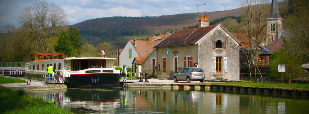 French Hotel Barge Savoir Vivre leaving lock in Burgundy France