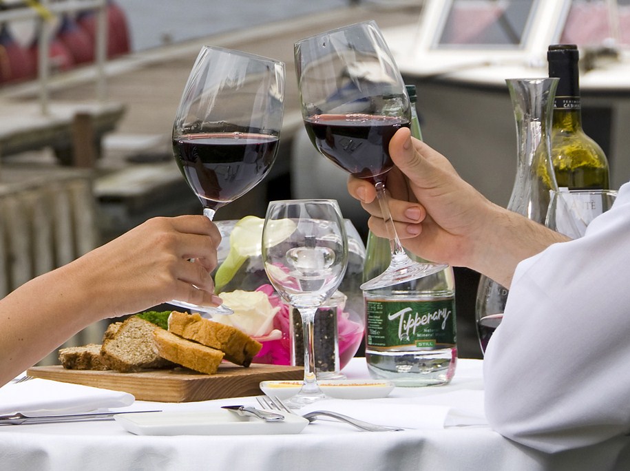 A couple having a wine toast aboard Irish Hotel Barge Shannon Princess