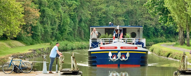 French Hotel Barge Renaissance entering a lock - Cruise the beautiful French canals