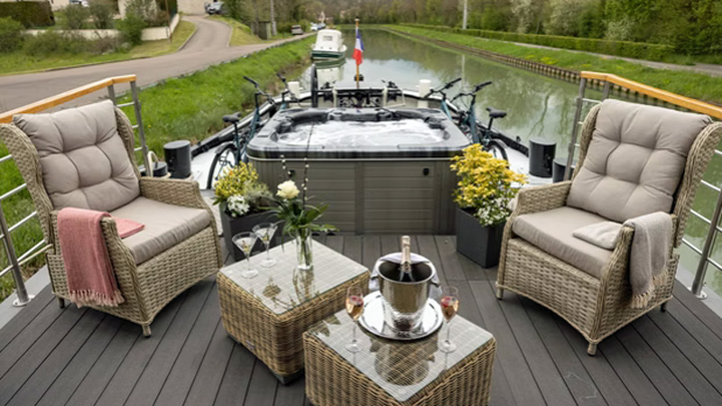 French Hotel Barge Rendez-Vous - Sundeck with comfortable seating, hot tub (spa pool), flower boxes, and bicycles